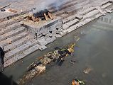 Kathmandu Pashupatinath 10 Burning Ghat At Edge of River The wood and what�s left of the burned body are dumped into the Bagmati River after the cremation at Pashupatinath in Kathmandu is over.